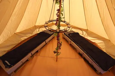 a tent with two black beds in it at Rescorla Retreats - Blossom in St Austell