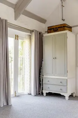 a white cabinet in a room with a window at Chypons Farm Bed & Breakfast in Penzance