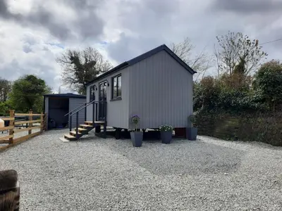 a tiny house sitting on top of a gravel lot at Beautiful Cabin near Padstow in Padstow