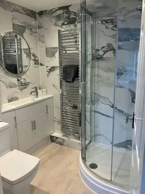 a bathroom with a shower and a toilet and a sink at Polmear Apartments, Charlestown in Charlestown