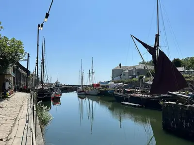a group of boats are docked in a canal at Polmear Apartments, Charlestown in Charlestown