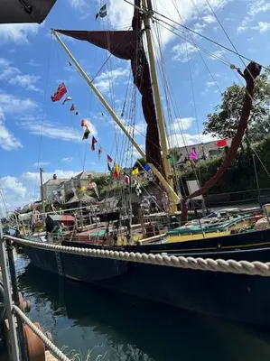 a large boat is docked in the water at Polmear Apartments, Charlestown in Charlestown