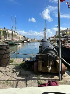 a boat is docked next to a body of water at Polmear Apartments, Charlestown in Charlestown