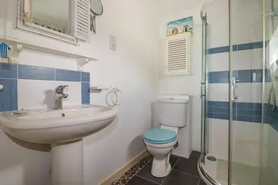 a bathroom with a sink and a toilet and a shower at Moonlight in Truro