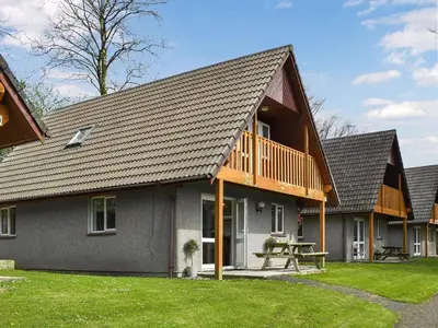 a row of cottages with a picnic table in the yard at Halcyons Rest in Saint Tudy
