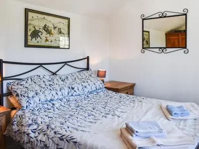 a bedroom with a bed with towels on it at Bray View Cottage in Davidstow
