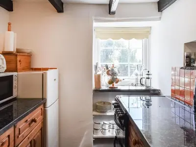 a kitchen with a white refrigerator and a window at Barn Cottage - Uk47089 in Davidstow