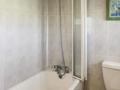 a bathroom with a bath tub and a toilet at Barn Cottage - Uk47089 in Davidstow