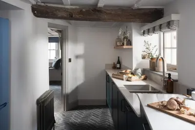 a kitchen with a sink and a counter top at Kittiwake Cottage - Charming harbour-side cottage, luxury interiors in Port Isaac