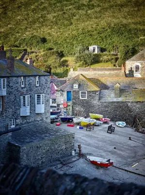 a group of buildings with boats in a parking lot at Kittiwake Cottage - Charming harbour-side cottage, luxury interiors in Port Isaac