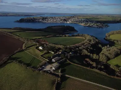 an aerial view of a river and a village at Barton Bothy in Porthscatho