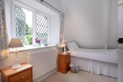 a bedroom with a bed and a window at Place Lodge in Porthscatho