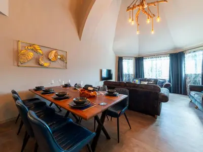 a living room with a wooden table and chairs at Holiday Home Tolcarne by Interhome in Newquay