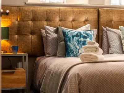 a bed with two towels on top of it at Holiday Home Seaside House by Interhome in Newquay