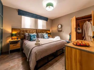 a bedroom with a large bed and a window at Holiday Home Seaside House by Interhome in Newquay