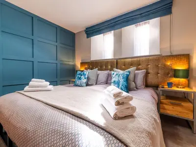 a bedroom with a large bed with towels on it at Holiday Home Seaside House by Interhome in Newquay