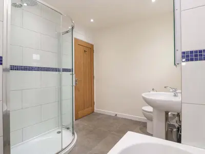 a bathroom with a shower and a sink and a toilet at Fair View in Truro