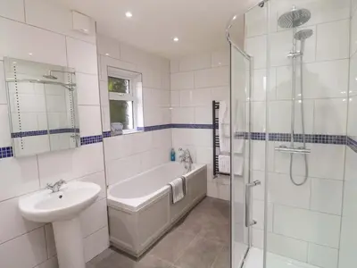 a bathroom with a sink and a tub and a shower at Fair View in Truro