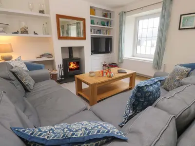 a living room with two couches and a fireplace at Fair View in Truro