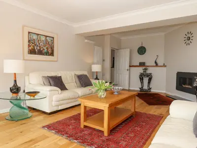 a living room with a white couch and a table at Seahaze in Torpoint