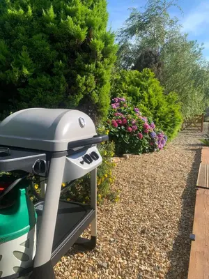a bike parked in a garden with flowers at TREKLYS Shepherds Hut in Otterham