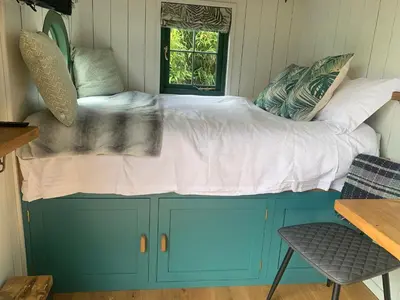 a bed on top of a cabinet in a room at TREKLYS Shepherds Hut in Otterham
