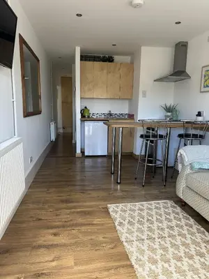 a kitchen and living room with a table and a counter at Trees Dale Lodge in Hayle in Hayle