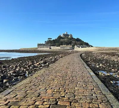 a brick road leading to a castle on an island at Trees Dale Lodge in Hayle in Hayle