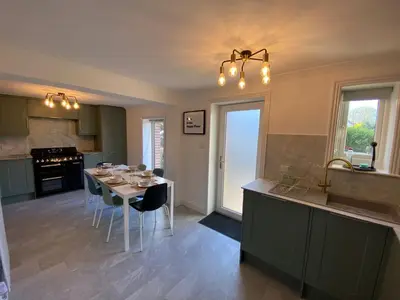 a kitchen with a table and a dining room at 4 Bed House in Lovely Cornish Town in Saint Columb Major