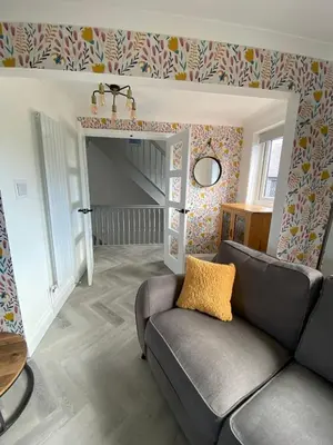 a living room with a couch and a staircase at 4 Bed House in Lovely Cornish Town in Saint Columb Major