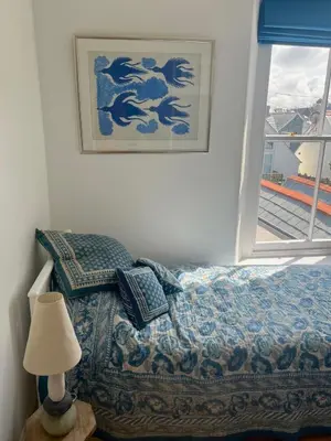 a bedroom with a bed with a lamp and a window at The Moorings - Just a few metres from the sea! in Padstow