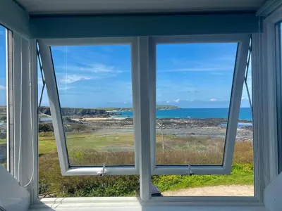 a window in a house looking out at the ocean at The Moorings - Just a few metres from the sea! in Padstow