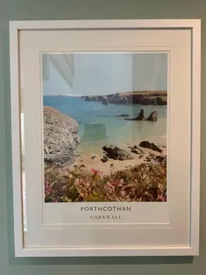 a picture of a beach with two people in the water at Sunnyridge Cottage, Porthcothan Bay in Saint Ervan