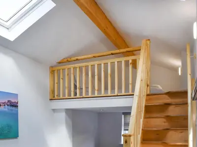 a ladder leading up to a loft in a house at The Boat House in Padstow