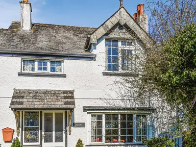a white house with windows and a roof at Nessa Cottage - Uk47087 in Davidstow