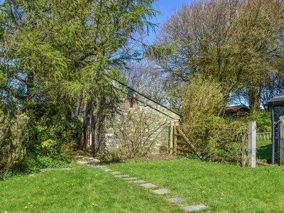 a path in a yard with trees and a fence at Nessa Cottage - Uk47087 in Davidstow