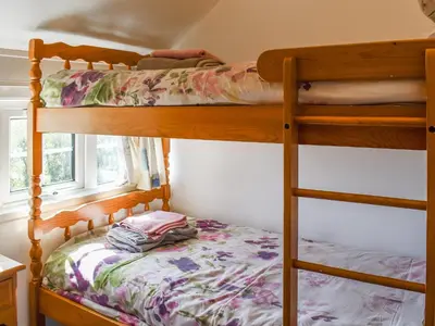 a bedroom with two bunk beds in a room at Nessa Cottage - Uk47087 in Davidstow