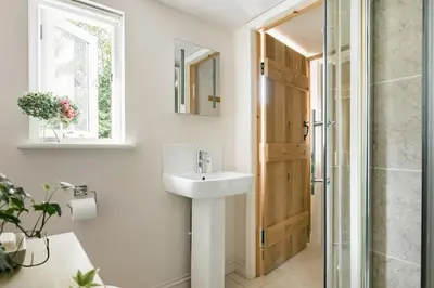 a bathroom with a sink and a shower at Little Trenant Barn on Helford River Near Constantine in Constantine