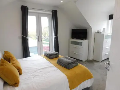 a bedroom with a large bed with two pillows on it at Ashwood bed and breakfast in Truro