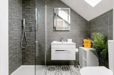 a bathroom with a shower and a toilet and a sink at Ashwood bed and breakfast in Truro