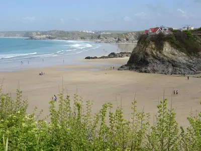 a group of people on a beach near the ocean at 6 Azure, Newquay in Newquay