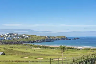 a golf course with a view of the ocean at 6 Azure, Newquay in Newquay