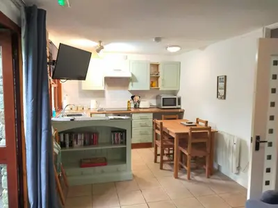 a kitchen with a table and a small kitchen with a dining room at Rebels Retreat - 2-Bed Chalet nr St Ives & Hayle in St Ives