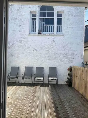 a group of chairs sitting in front of a building at Truro City Escape (self contained apartment) in Truro