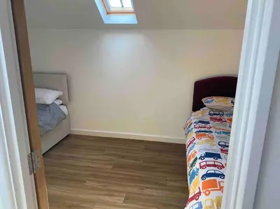 a small bedroom with a bed and a window at Truro City Escape (self contained apartment) in Truro