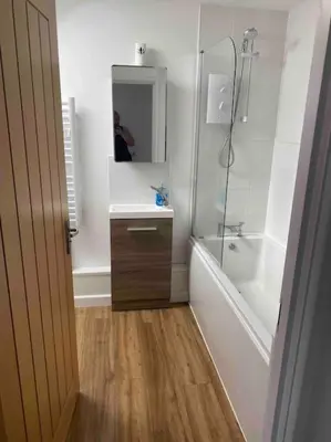 a bathroom with a tub and a sink and a mirror at Truro City Escape (self contained apartment) in Truro