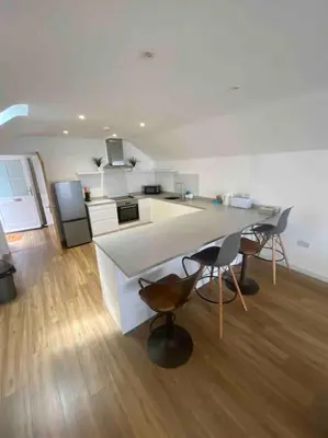 a kitchen with a table and chairs in a room at Truro City Escape (self contained apartment) in Truro