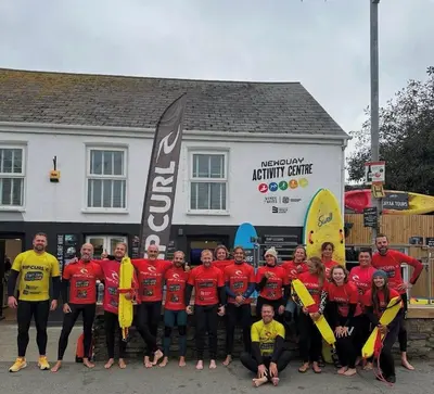 a group of people posing for a picture in front of a building at Palms 1 Log Burner Private Courtyard Parking Central Newquay in Newquay