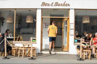 a man standing in the doorway of a bar and bakery at Palms 1 Log Burner Private Courtyard Parking Central Newquay in Newquay