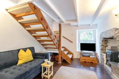 a living room with a couch and a tv at 5 Bed in Little Petherick oc-melynw in Little Petherick